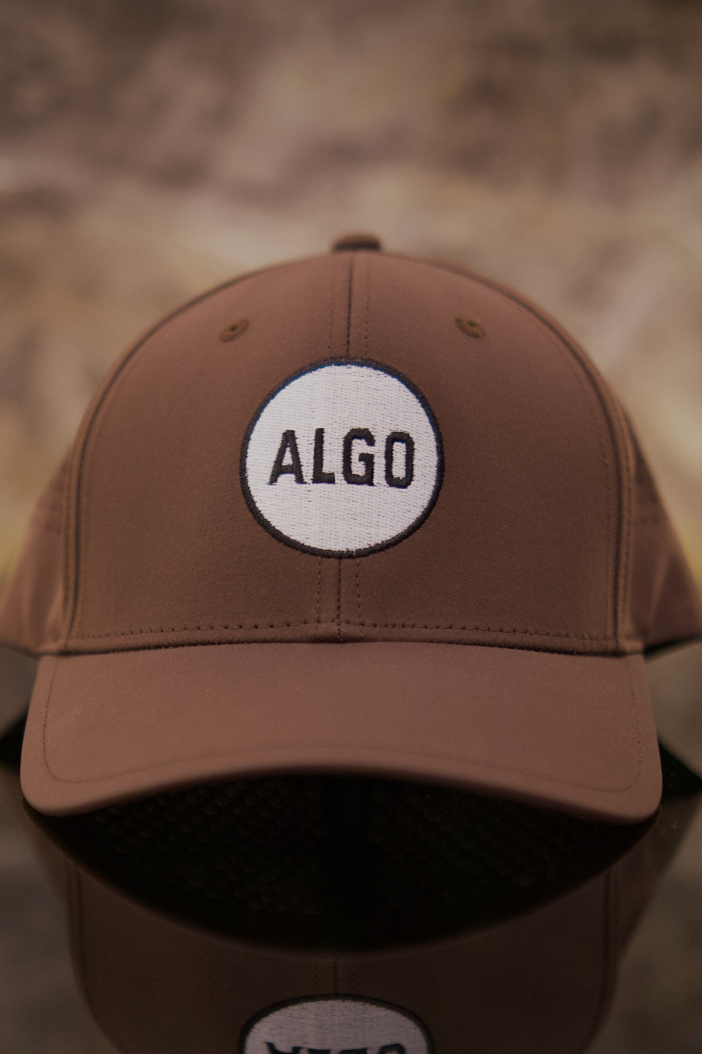 A sleek, white ALGO performance golf cap.